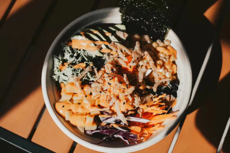 Poke bowl with kale, avocado, corn, crispy toppings, and orange sauce at Natural Kitchen Wilton, a Fast Casual Restaurant in Wilton